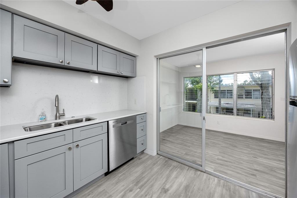 4152 55th Way North, Unit 1028 Kenneth City, FL 33709 - Photo 17 of 46 a kitchen with sink cabinets and window