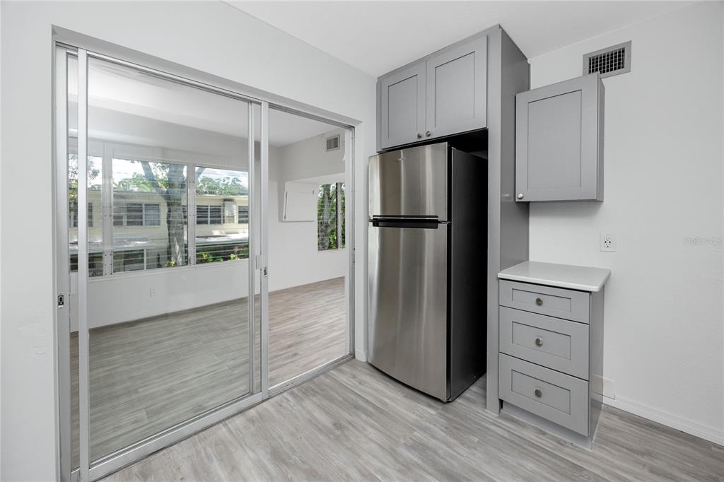 4152 55th Way North, Unit 1028 Kenneth City, FL 33709 - Photo 19 of 46 a kitchen with a refrigerator and a more cabinets