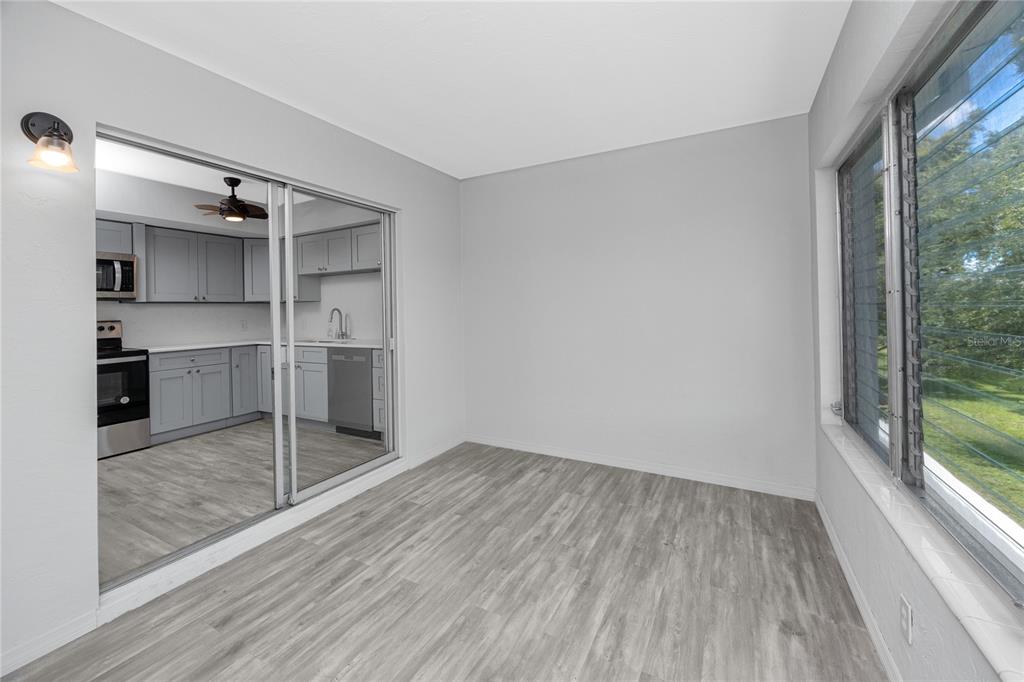 4152 55th Way North, Unit 1028 Kenneth City, FL 33709 - Photo 20 of 46 a view of a kitchen with wooden floor and electronic appliances