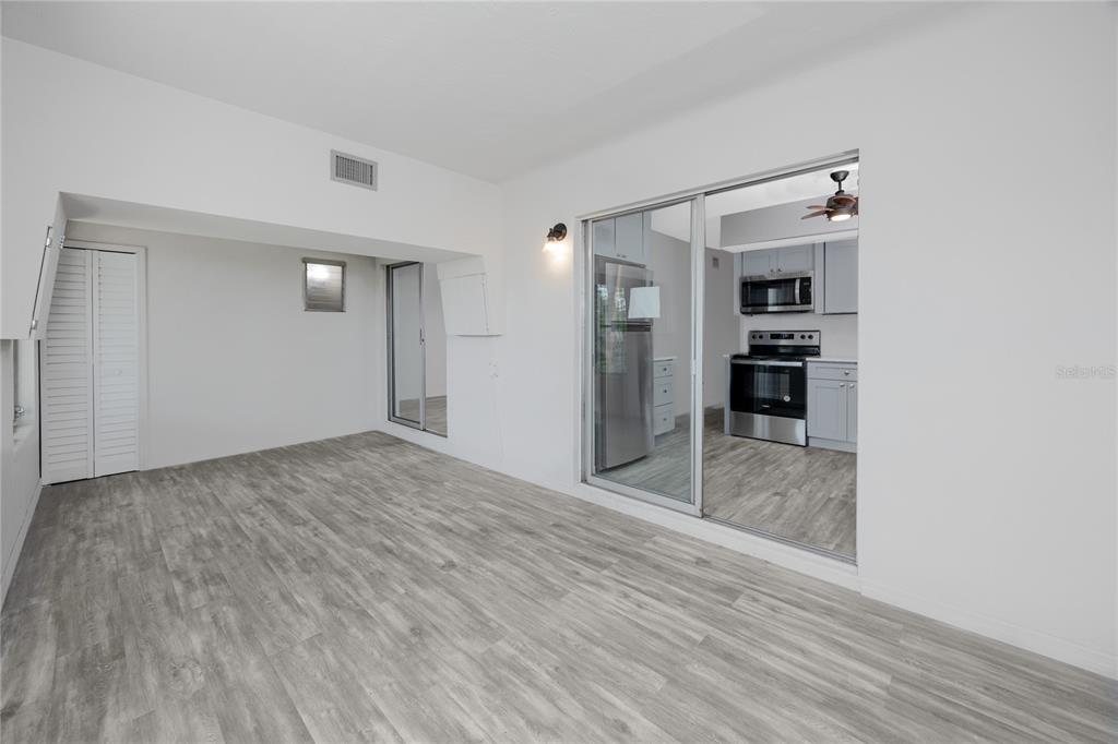 4152 55th Way North, Unit 1028 Kenneth City, FL 33709 - Photo 22 of 46 a view of empty room with wooden floor and cabinet