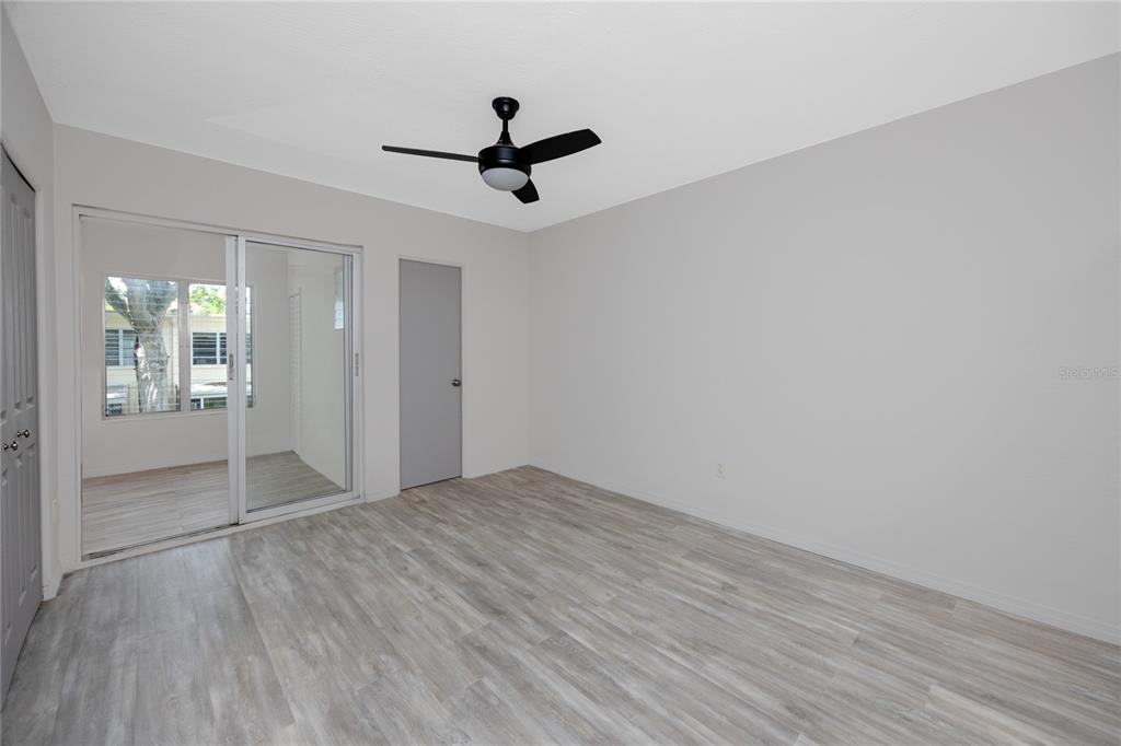 4152 55th Way North, Unit 1028 Kenneth City, FL 33709 - Photo 27 of 46 wooden floor in an empty room