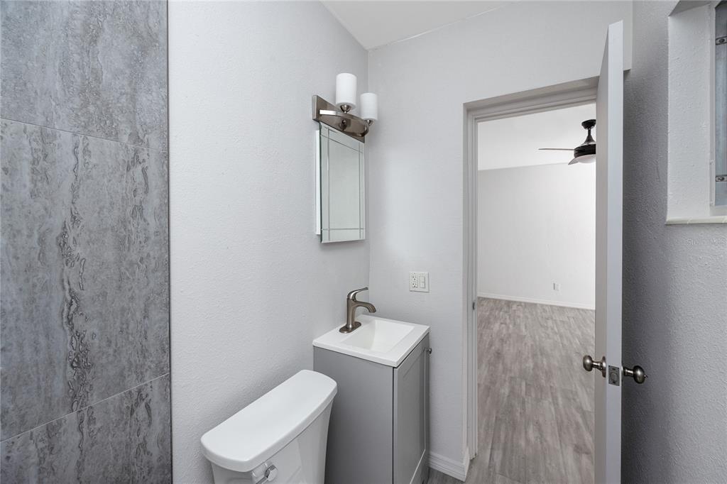 4152 55th Way North, Unit 1028 Kenneth City, FL 33709 - Photo 31 of 46 a white toilet sitting next to a bathroom sink