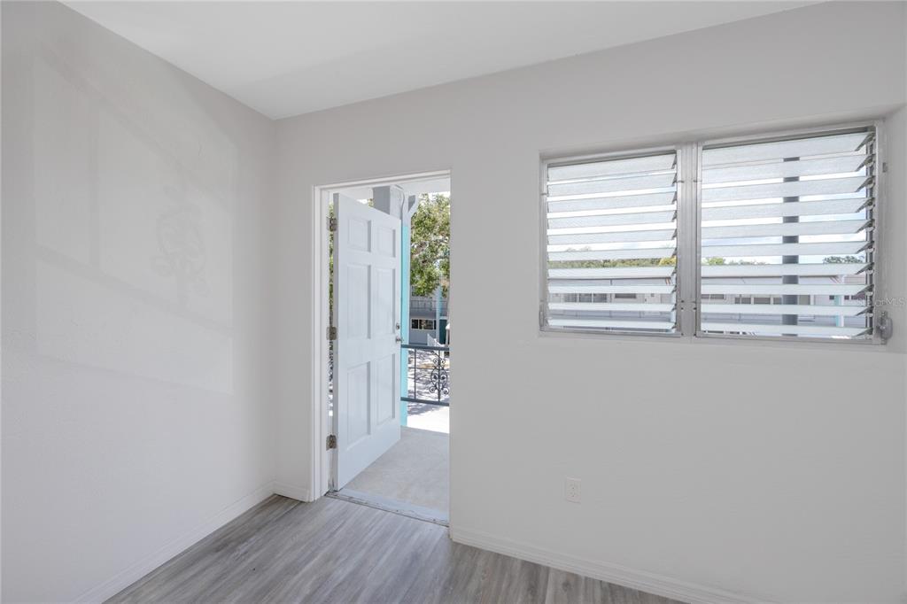 4152 55th Way North, Unit 1028 Kenneth City, FL 33709 - Photo 33 of 46 a view of empty room with wooden floor and fan