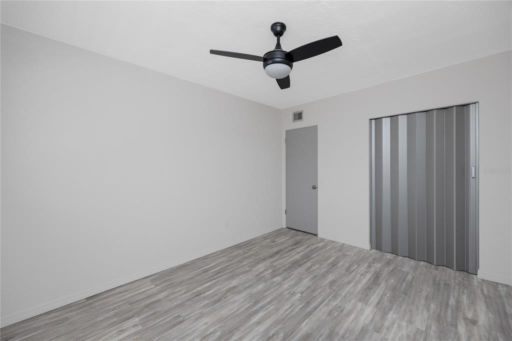 4152 55th Way North, Unit 1028 Kenneth City, FL 33709 - Photo 34 of 46 wooden floor in an empty room