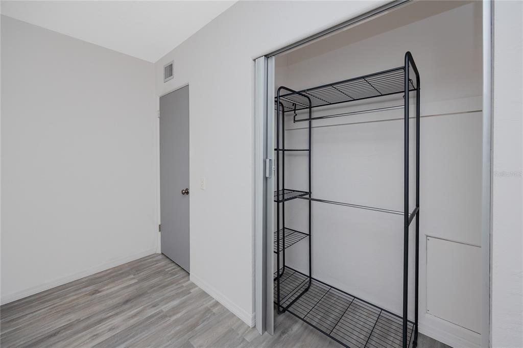 4152 55th Way North, Unit 1028 Kenneth City, FL 33709 - Photo 35 of 46 a view of a room with wooden floor