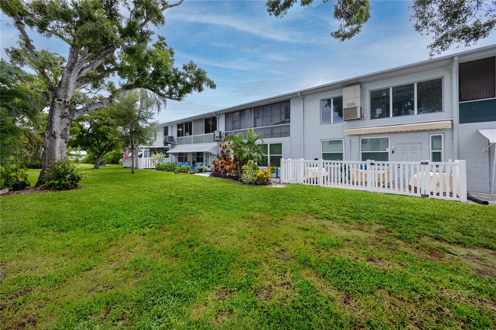 4152 55th Way North, Unit 1028 Kenneth City, FL 33709 - Photo 40 of 46 a front view of house with yard and green space