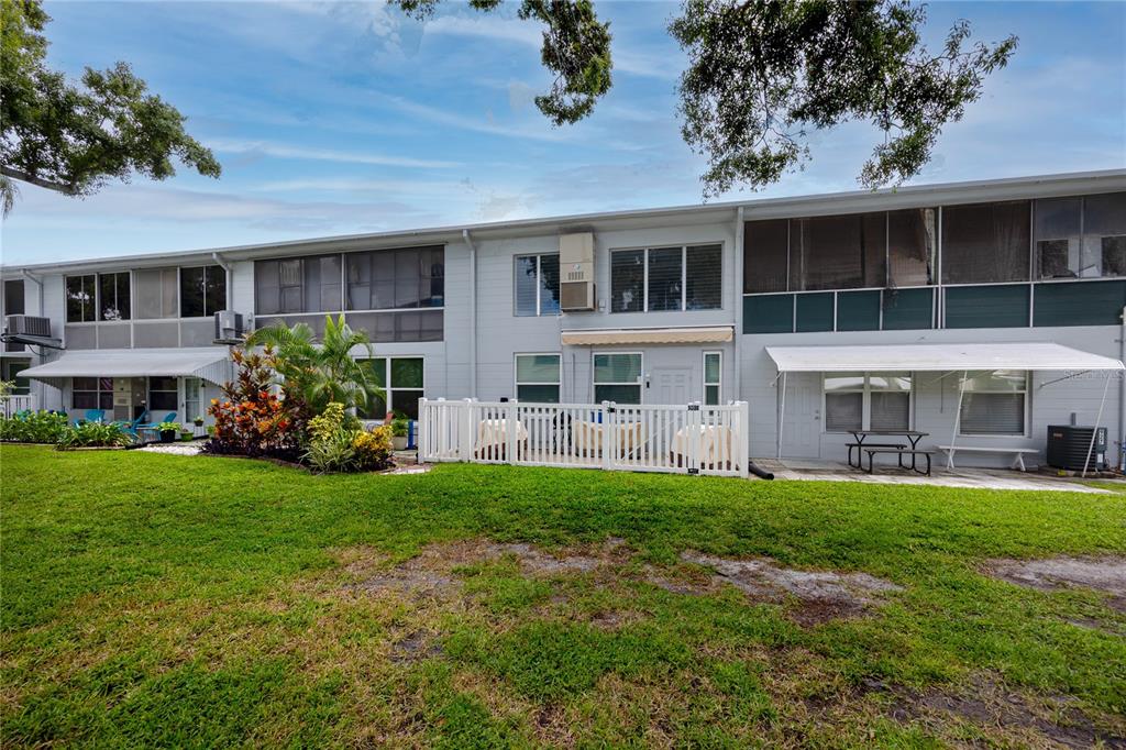 4152 55th Way North, Unit 1028 Kenneth City, FL 33709 - Photo 41 of 46 a house view with a garden space