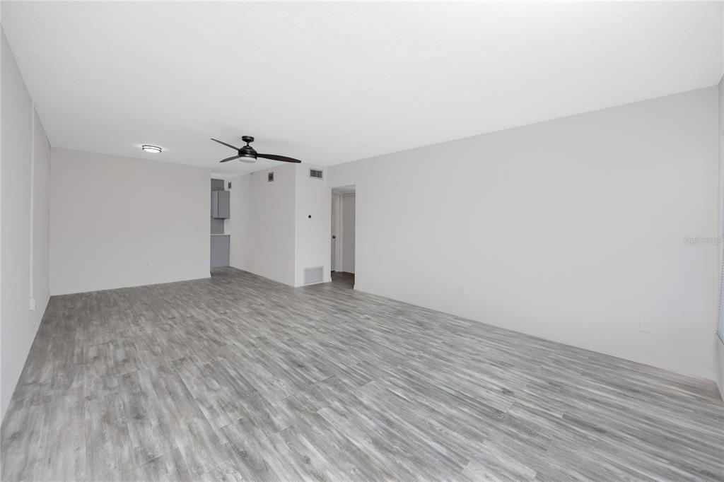 4152 55th Way North, Unit 1028 Kenneth City, FL 33709 - Photo 6 of 46 a view of a livingroom with wooden floor