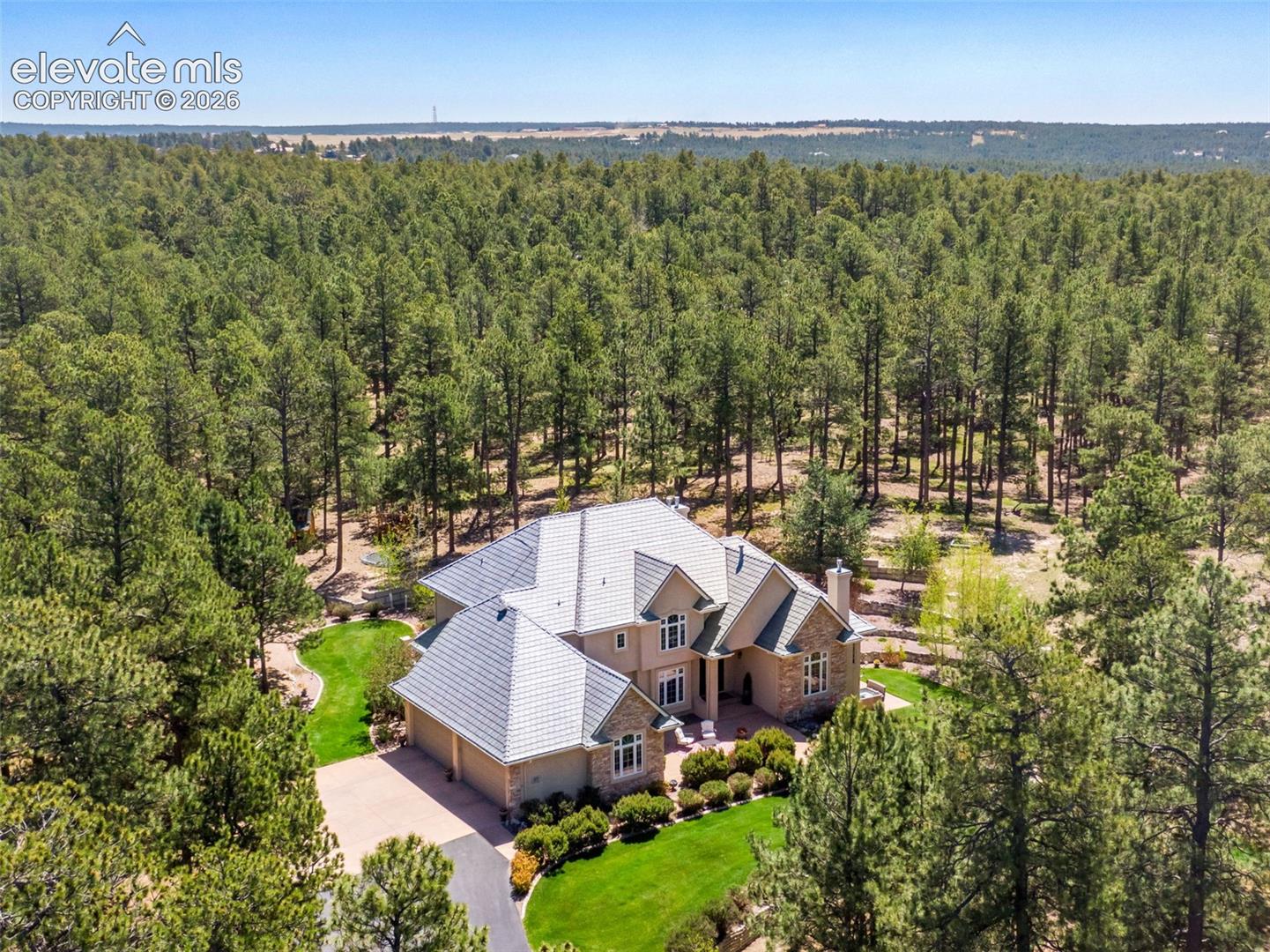 Aerial view from the front of the house showing courtyard and green lawn space