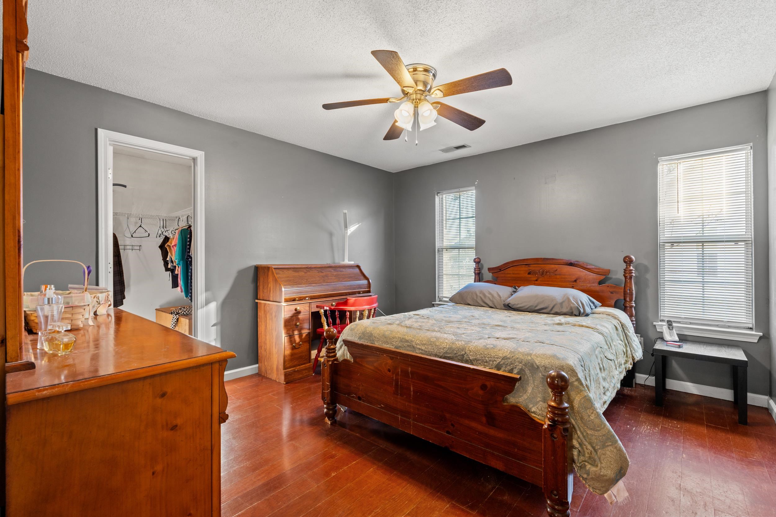 539 Drake Lane Surfside Beach, SC 29575 - Photo 12 of 38 Bedroom with a spacious closet, dark wood-style flooring, a ceiling fan, and a textured ceiling