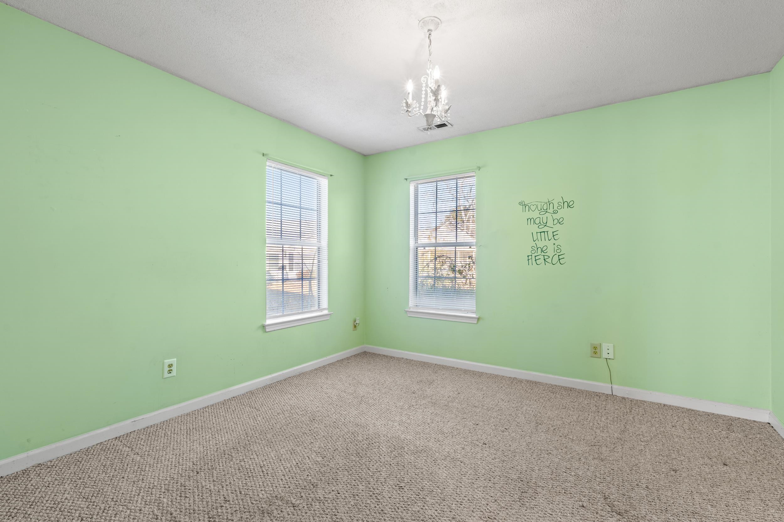 539 Drake Lane Surfside Beach, SC 29575 - Photo 15 of 38 Spare room with carpet, a chandelier, and a textured ceiling