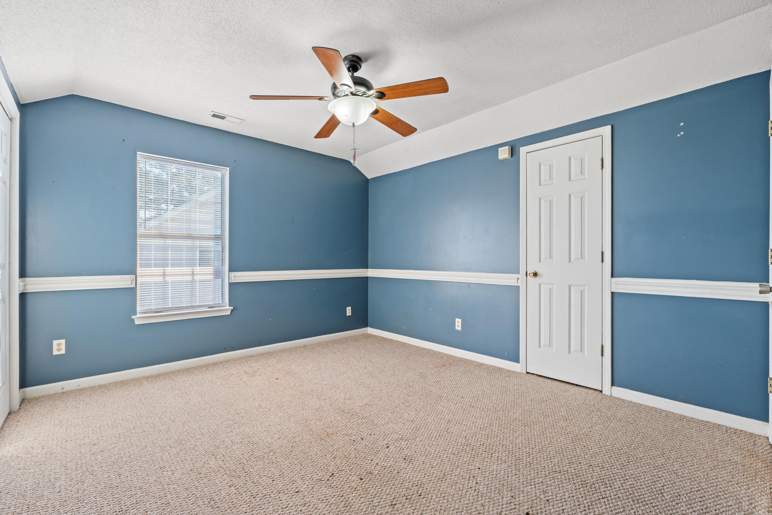 539 Drake Lane Surfside Beach, SC 29575 - Photo 18 of 38 Empty room featuring carpet, ceiling fan, vaulted ceiling, and a textured ceiling