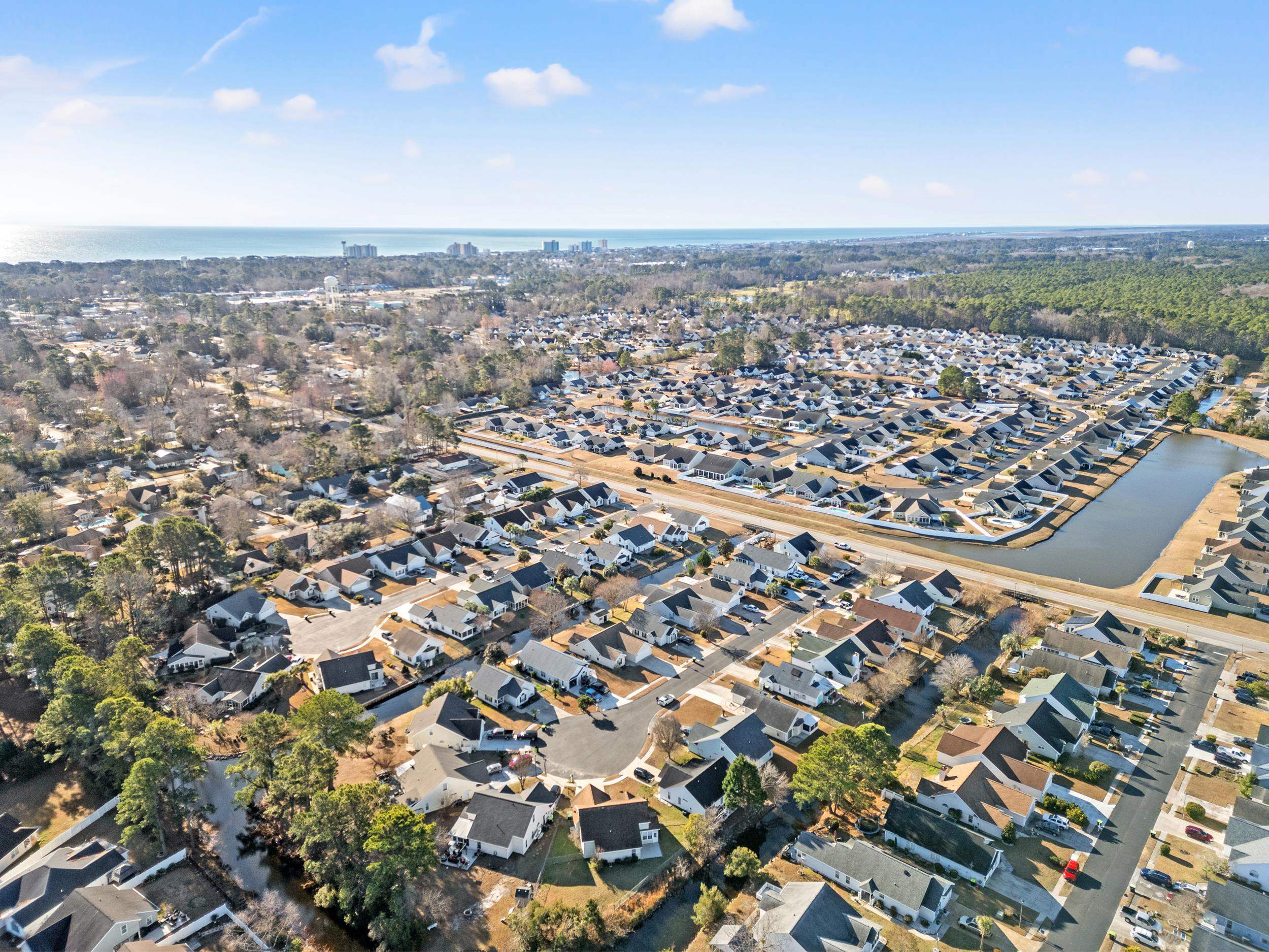 539 Drake Lane Surfside Beach, SC 29575 - Photo 32 of 38 Aerial view of property and surrounding area with a large body of water and nearby suburban area