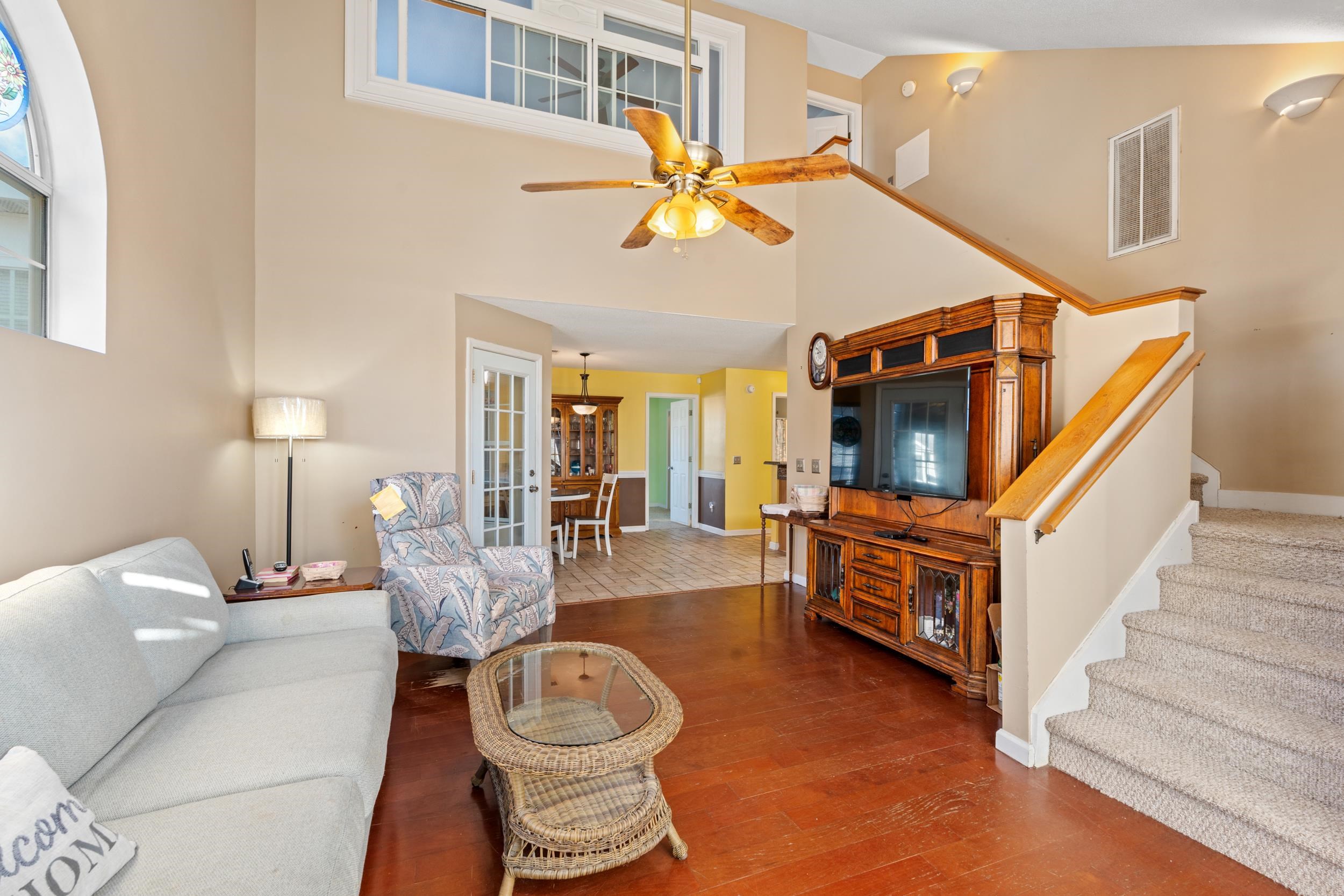 539 Drake Lane Surfside Beach, SC 29575 - Photo 5 of 38 Living room with a ceiling fan, hardwood / wood-style flooring, stairs, high vaulted ceiling, and french doors