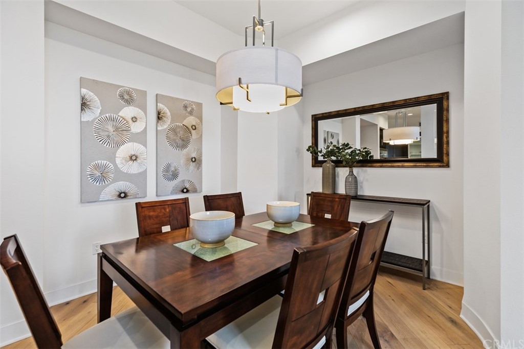 402 Rockefeller, Unit 406 Irvine, CA 92612 - Photo 2 of 35 a view of a dining room with furniture and wooden floor