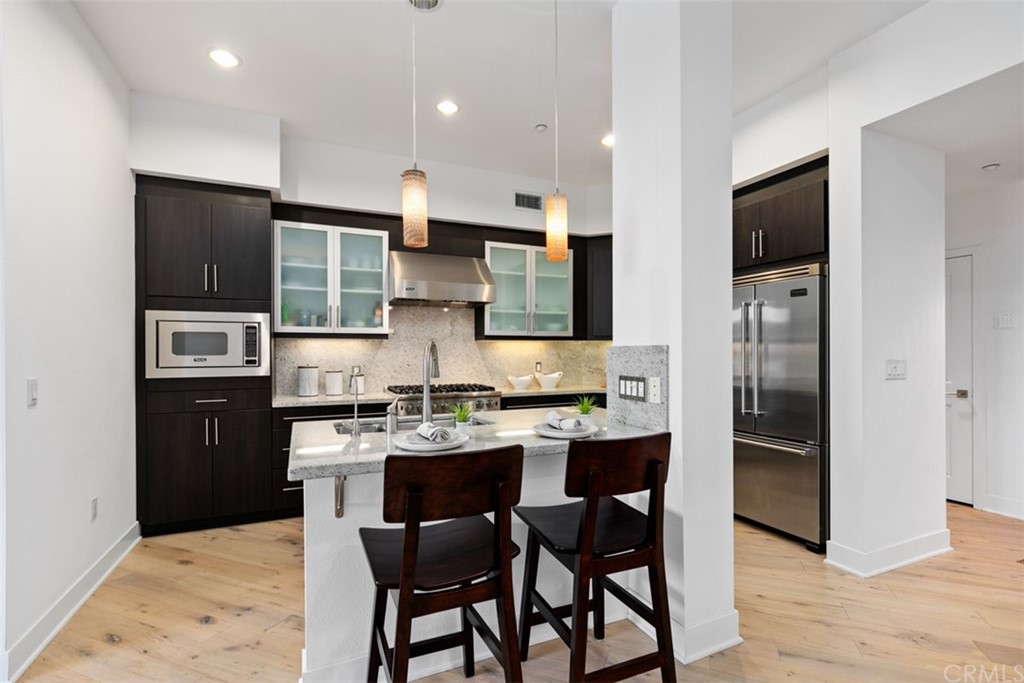 402 Rockefeller, Unit 406 Irvine, CA 92612 - Photo 5 of 35 a kitchen with stainless steel appliances kitchen island granite countertop a sink and cabinets