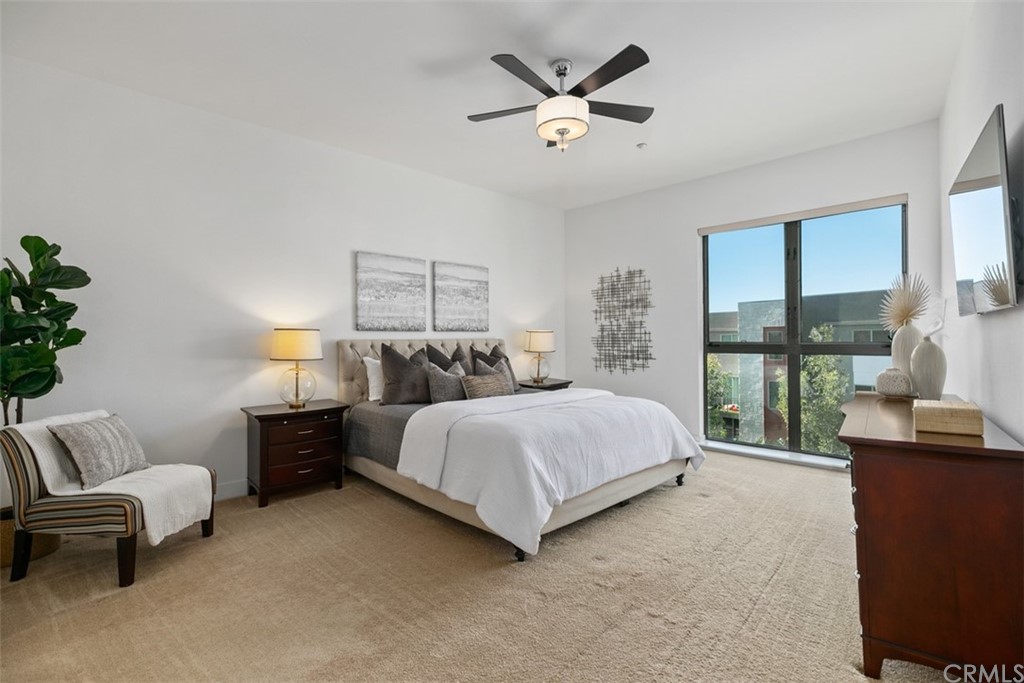 402 Rockefeller, Unit 406 Irvine, CA 92612 - Photo 6 of 35 a spacious bedroom with a bed and a large window