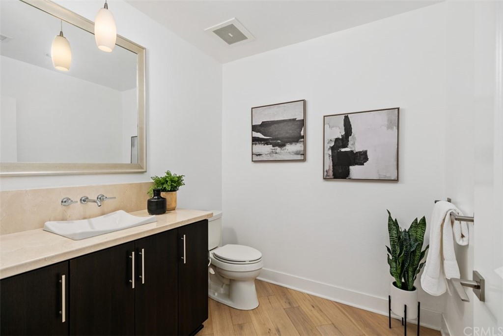 402 Rockefeller, Unit 406 Irvine, CA 92612 - Photo 10 of 35 a bathroom with a toilet sink and mirror