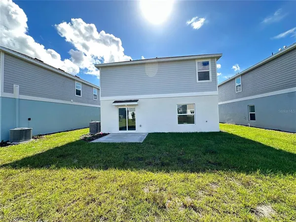 a view of a backyard with plants and a patio