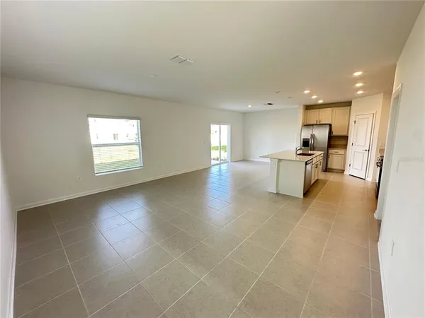 a view of a livingroom with furniture wooden floor and windows