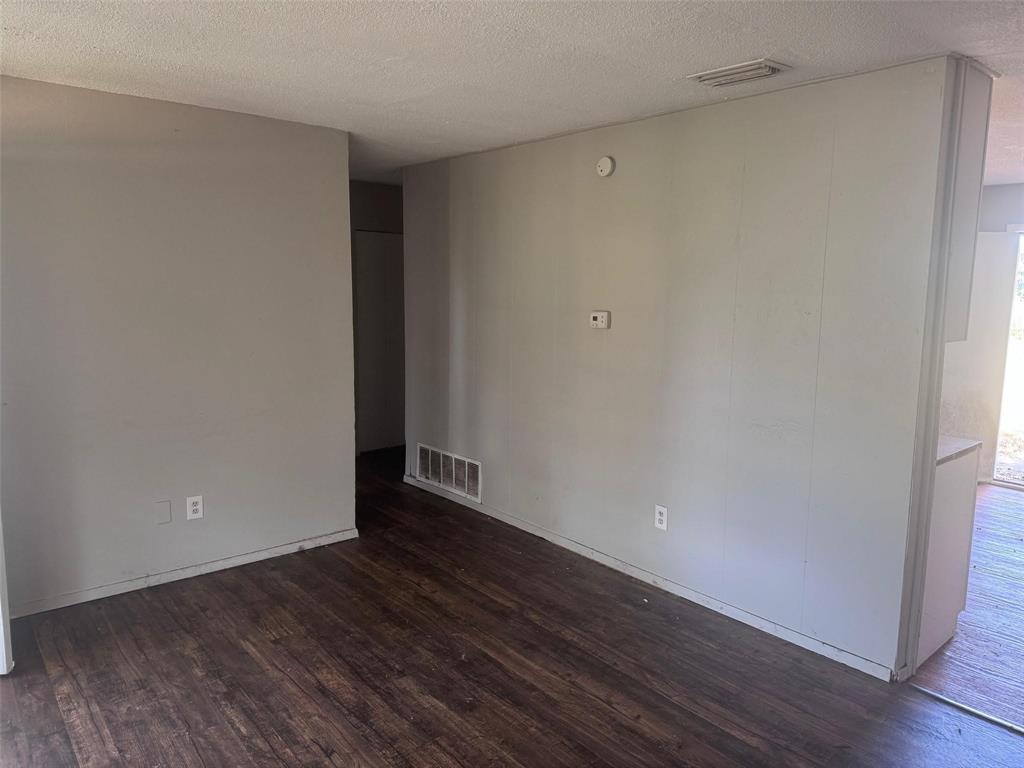 2112 Sunset Drive Brookston, TX 75421 - Photo 2 of 8 a view of an empty room with wooden floor