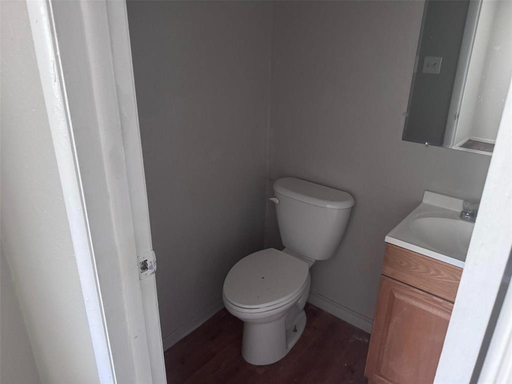 2112 Sunset Drive Brookston, TX 75421 - Photo 6 of 8 a white toilet sitting next to a small window