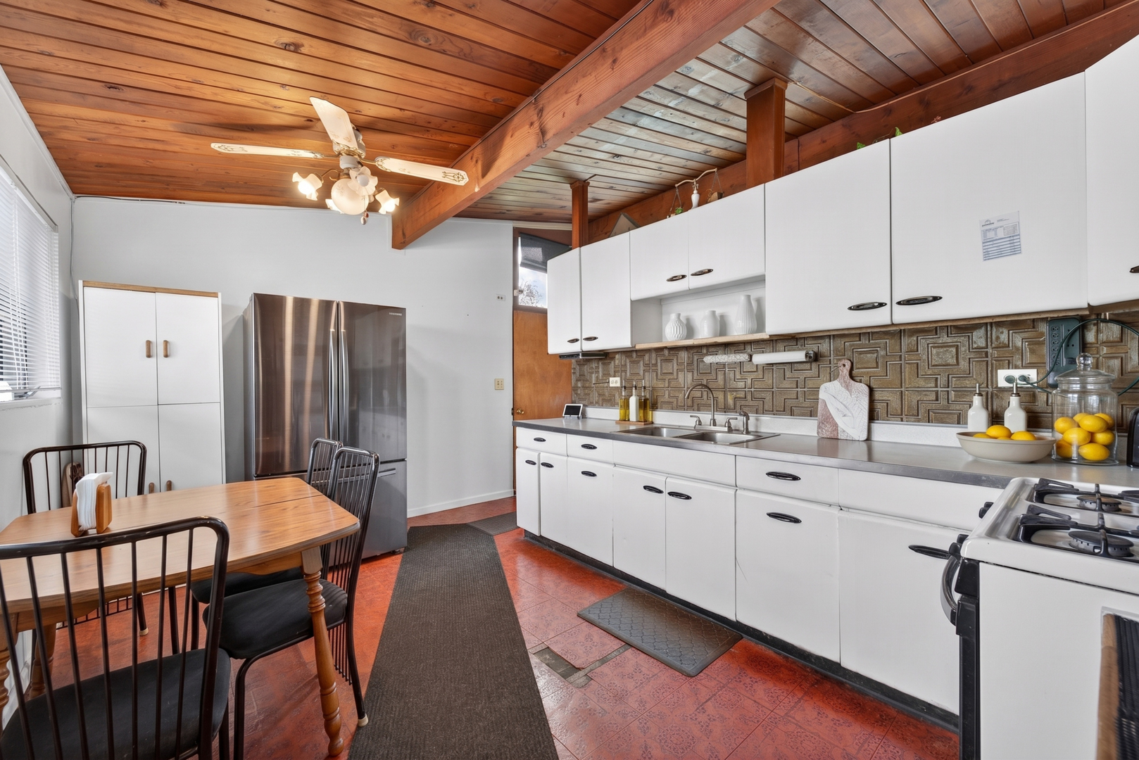 308 Natoma Avenue Addison, IL 60101 - Photo 4 of 21 a kitchen with stainless steel appliances granite countertop a sink a stove a refrigerator cabinets and chairs