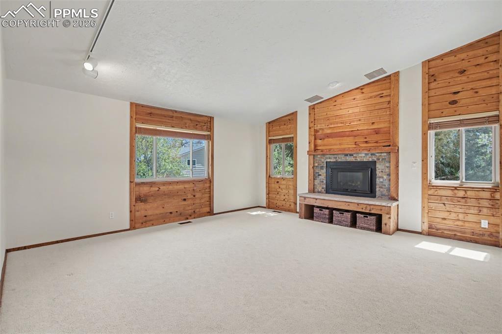 5301 Pinon Valley Road Colorado Springs, CO 80919 - Photo 7 of 27 an empty room with furniture and a flat screen tv