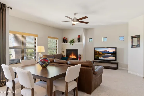 a living room with furniture a flat screen tv and a large window