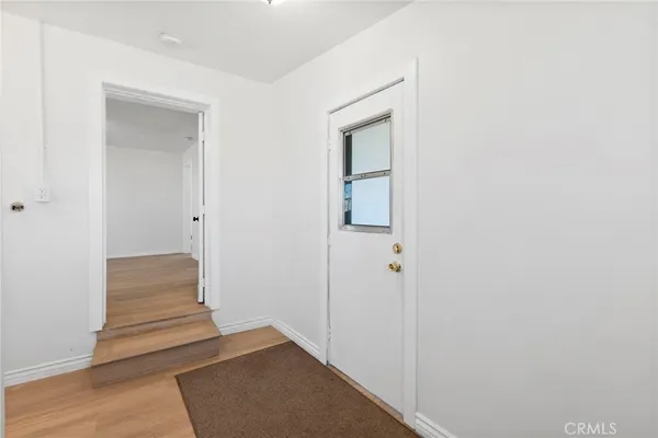 a view of front door with wooden floor