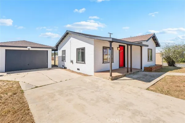 a view of a house with snow on the road