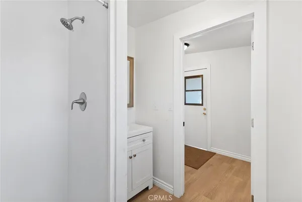 a view of a bathroom from a hallway