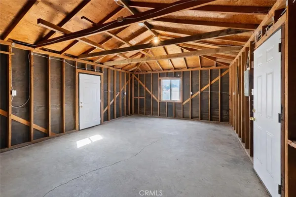 a view of empty room with wooden walls