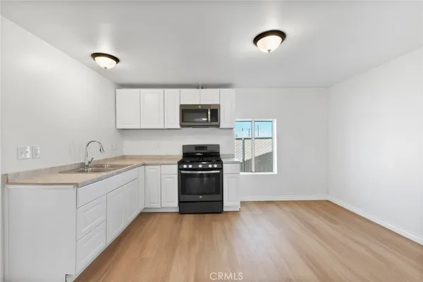 a kitchen with a sink and a stove top oven