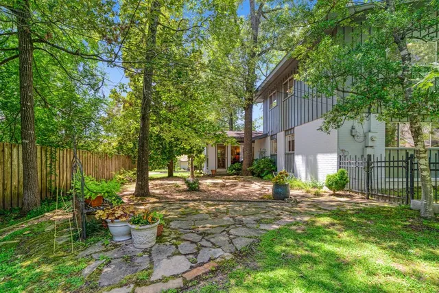 a view of a patio with table and chairs and potted plants