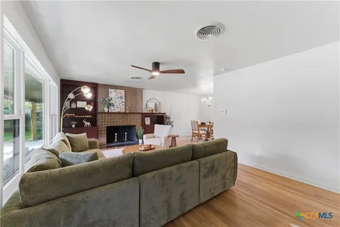 a kitchen with stainless steel appliances granite countertop a refrigerator a sink and wooden cabinets