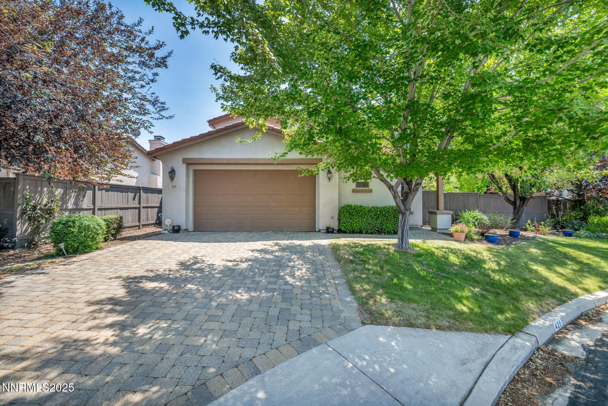 a front view of a house with a yard and a garage