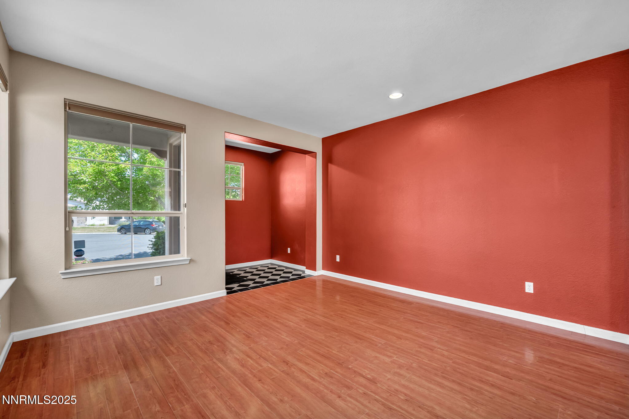 420 Miesque Court Reno, NV 89521 - Photo 11 of 43 an empty room with wooden floor and windows