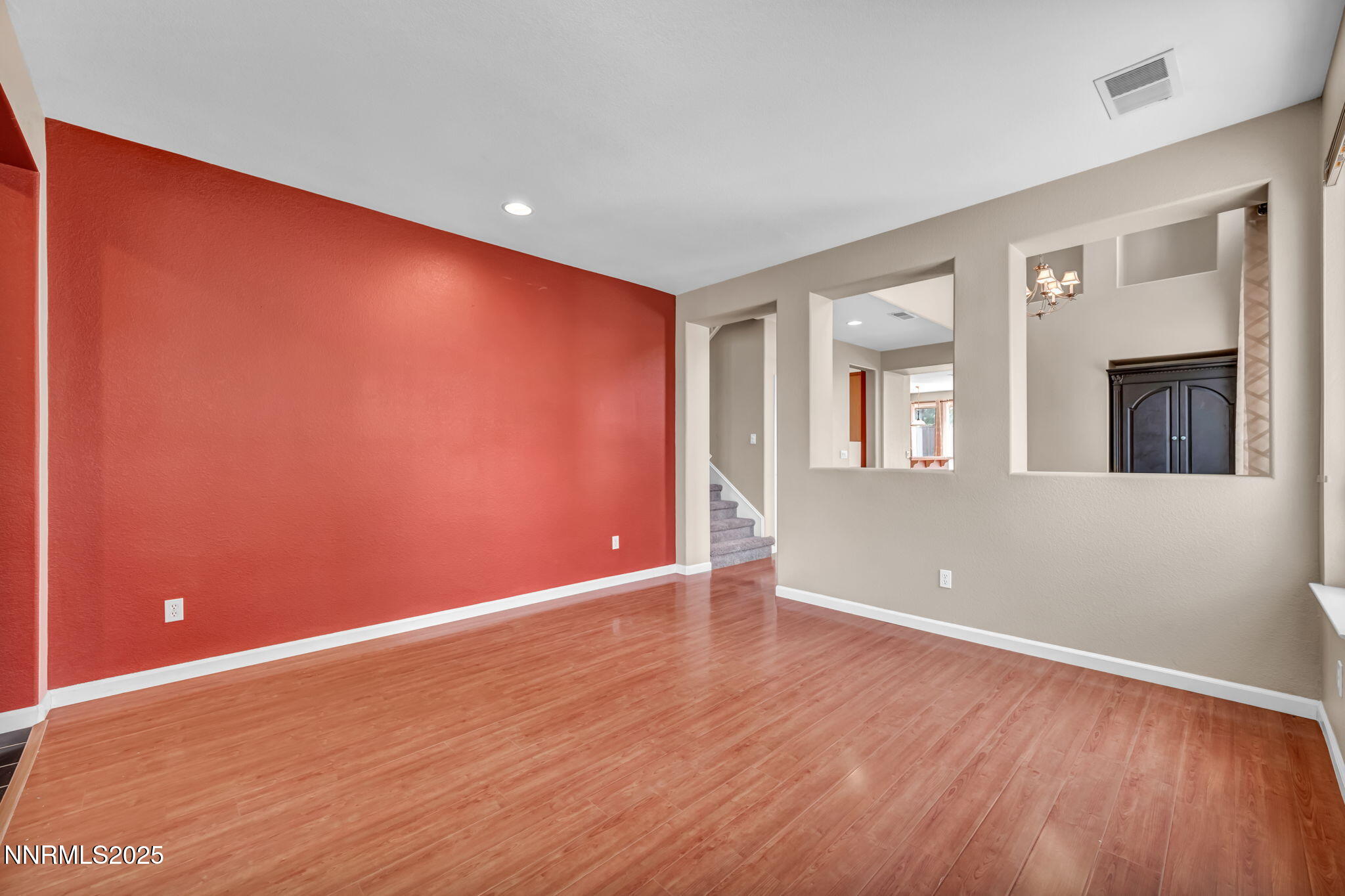 420 Miesque Court Reno, NV 89521 - Photo 12 of 43 a view of an empty room with wooden floor and a window
