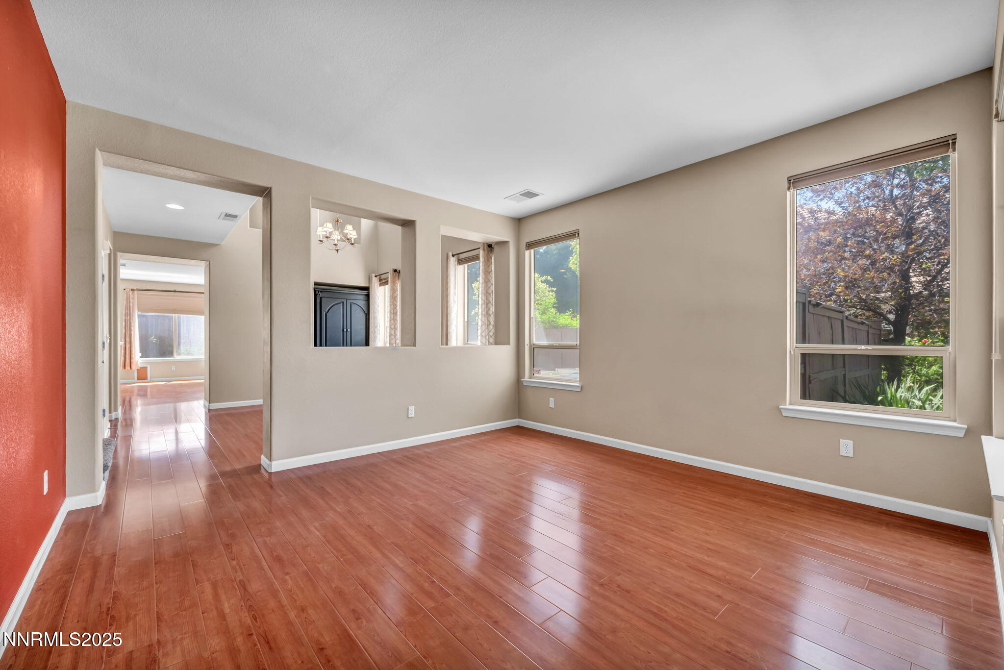 420 Miesque Court Reno, NV 89521 - Photo 13 of 43 a view of an empty room with wooden floor and a window