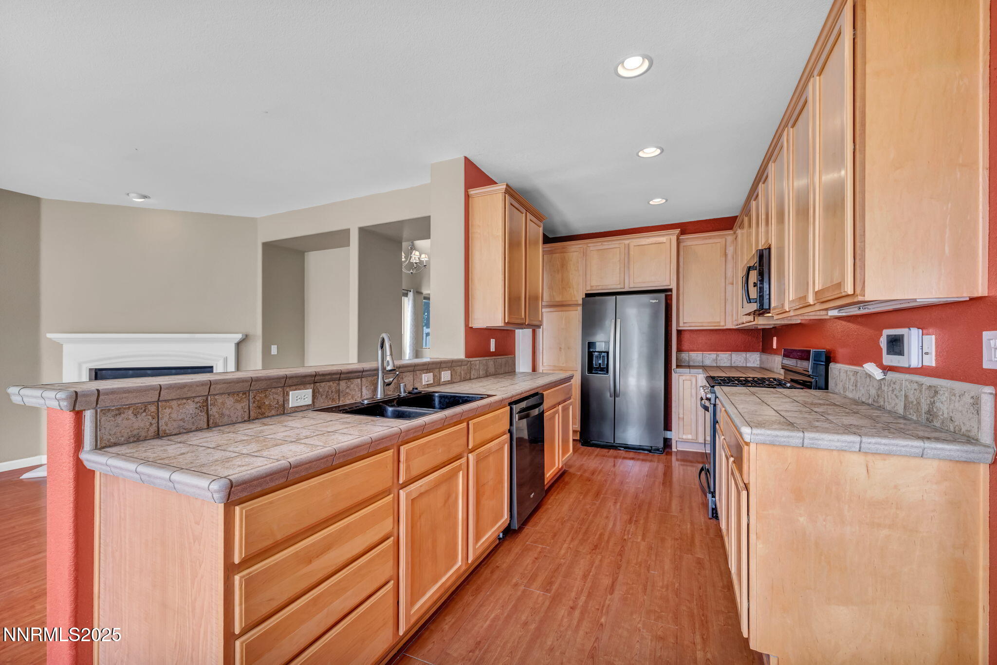 420 Miesque Court Reno, NV 89521 - Photo 14 of 43 a kitchen with stainless steel appliances granite countertop a sink stove and refrigerator