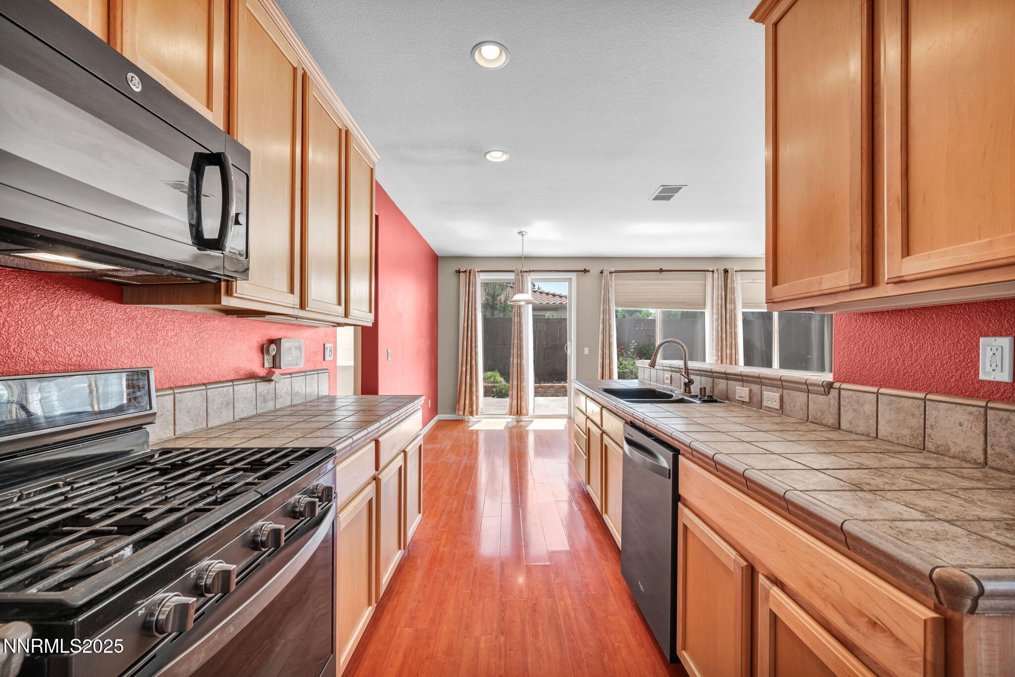 420 Miesque Court Reno, NV 89521 - Photo 16 of 43 a kitchen with granite countertop a stove and a sink