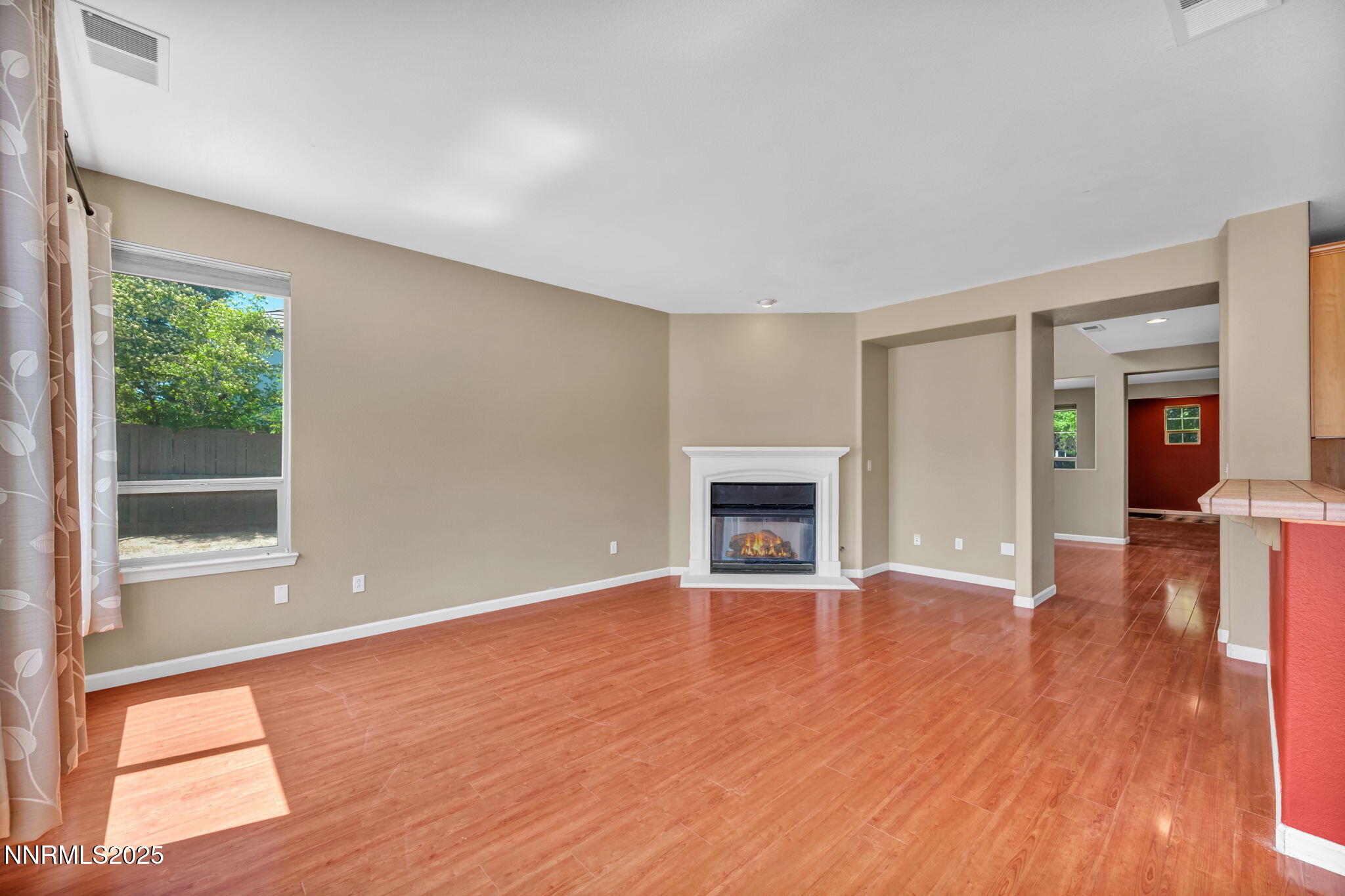 420 Miesque Court Reno, NV 89521 - Photo 2 of 43 a view of empty room with wooden floor and fireplace
