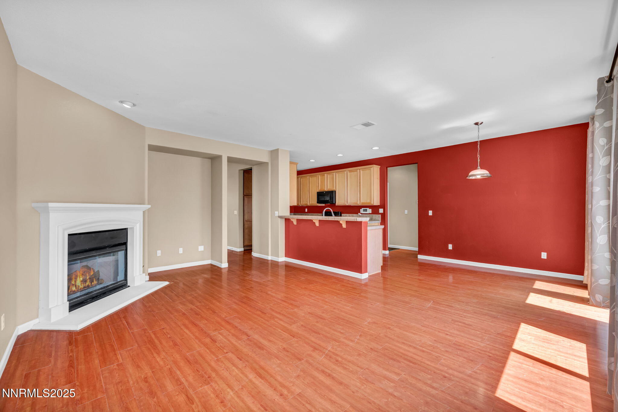 420 Miesque Court Reno, NV 89521 - Photo 3 of 43 a view of empty room with wooden floor and fireplace