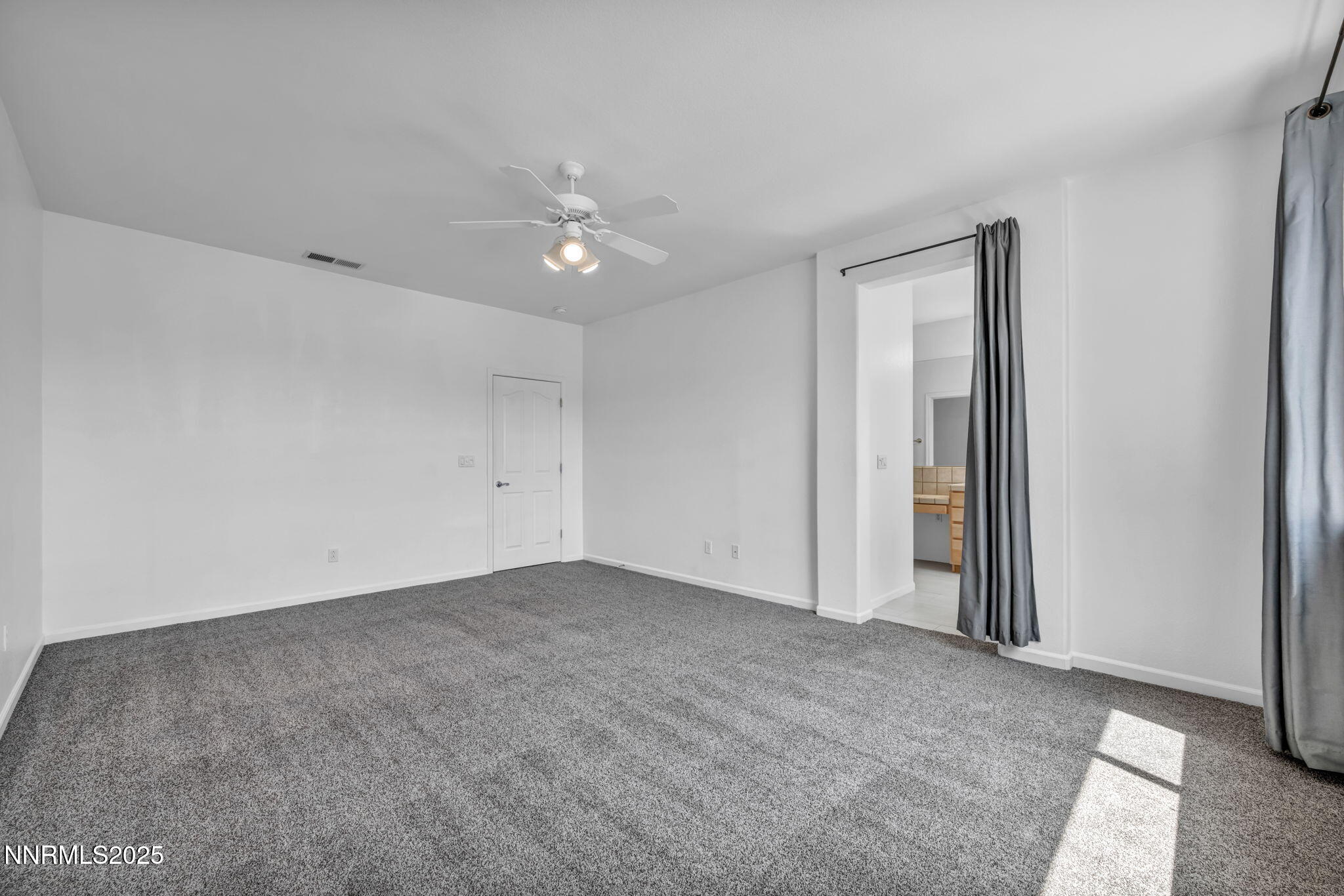 420 Miesque Court Reno, NV 89521 - Photo 33 of 43 an empty room with a ceiling fan and a window