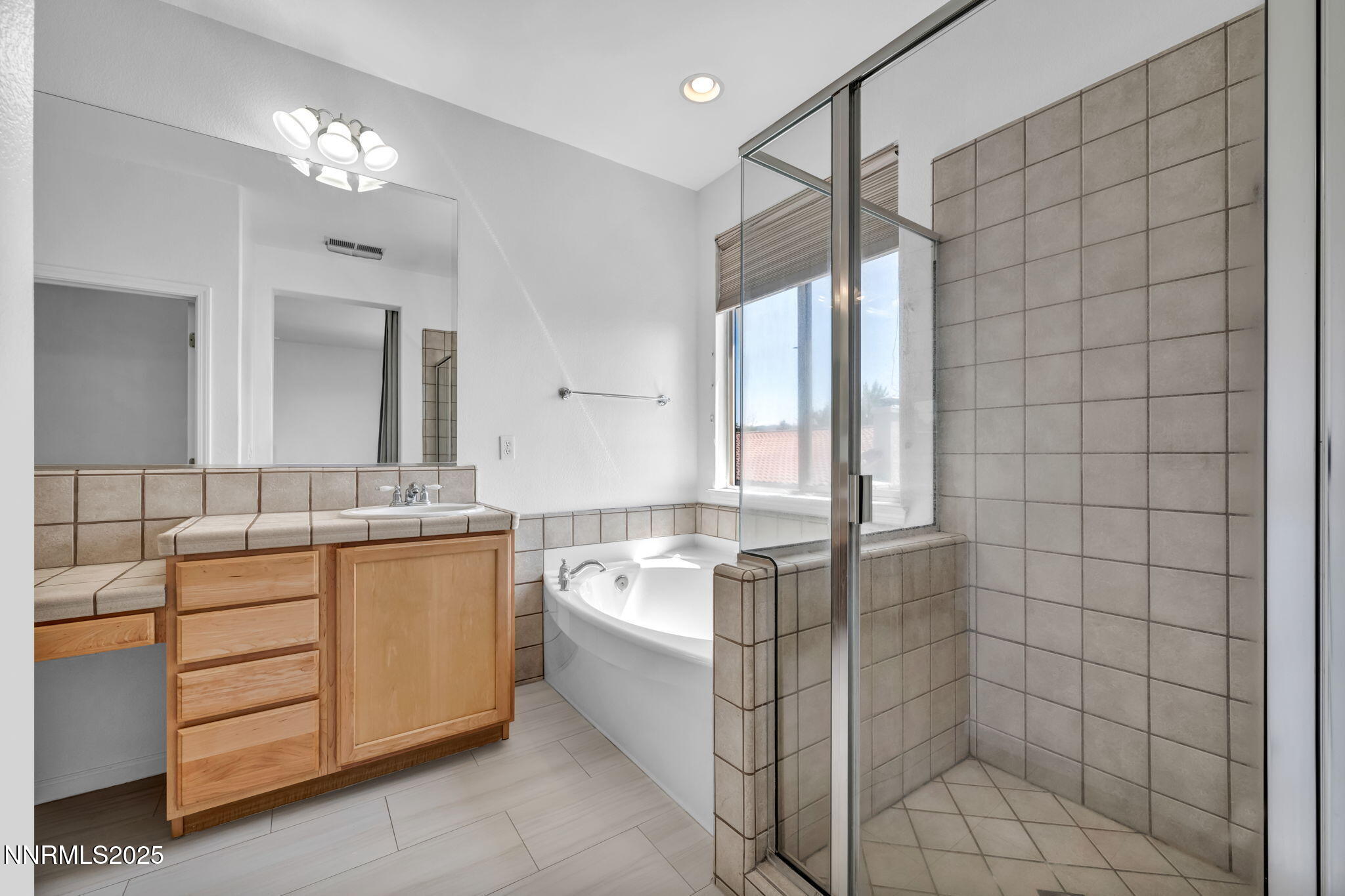 420 Miesque Court Reno, NV 89521 - Photo 34 of 43 a spacious bathroom with a double vanity sink a mirror and a bathtub
