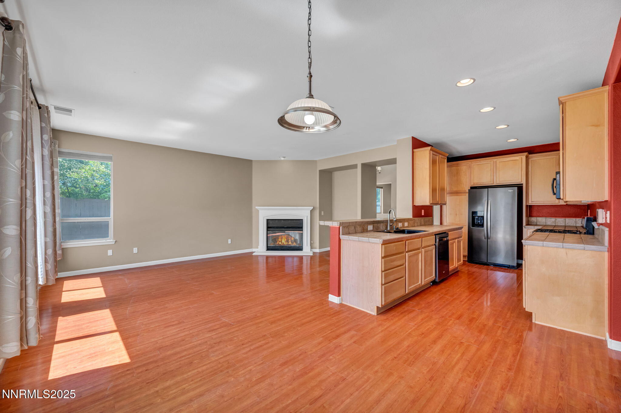 420 Miesque Court Reno, NV 89521 - Photo 4 of 43 a kitchen with stainless steel appliances granite countertop a refrigerator a stove top oven and wooden floors