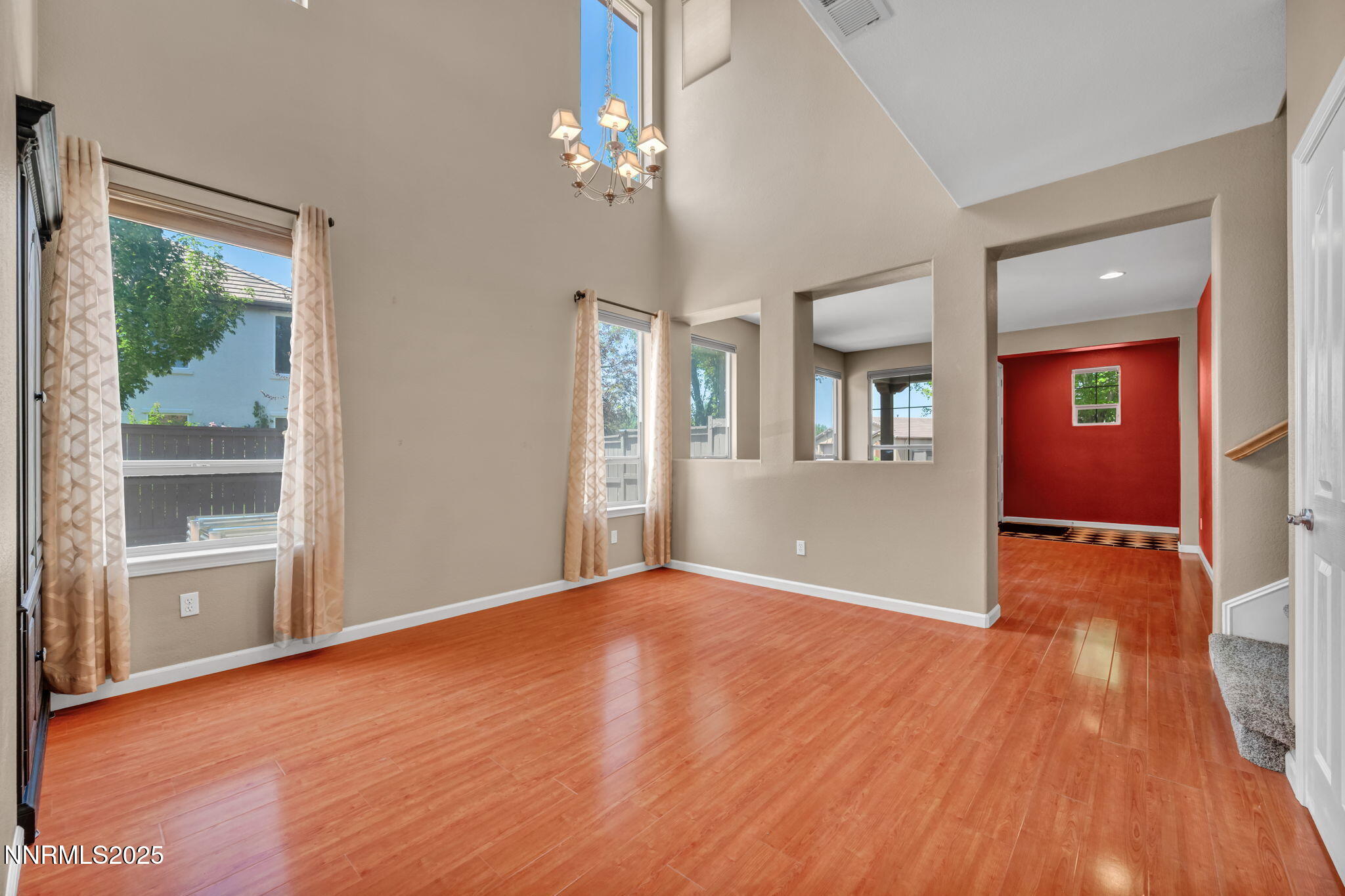 420 Miesque Court Reno, NV 89521 - Photo 5 of 43 a view of an empty room with a window and wooden floor