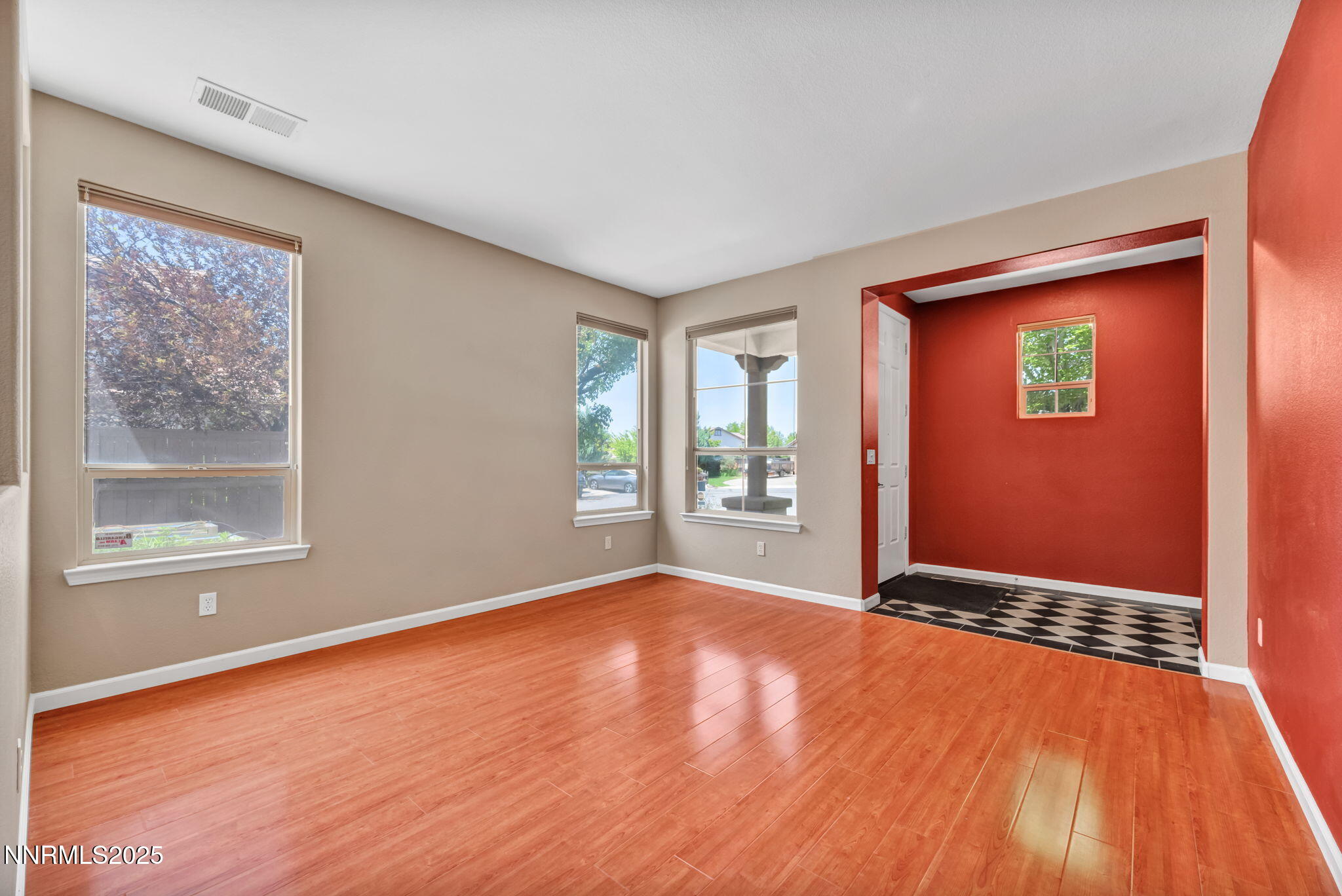 420 Miesque Court Reno, NV 89521 - Photo 7 of 43 a view of an empty room with a window and wooden floor