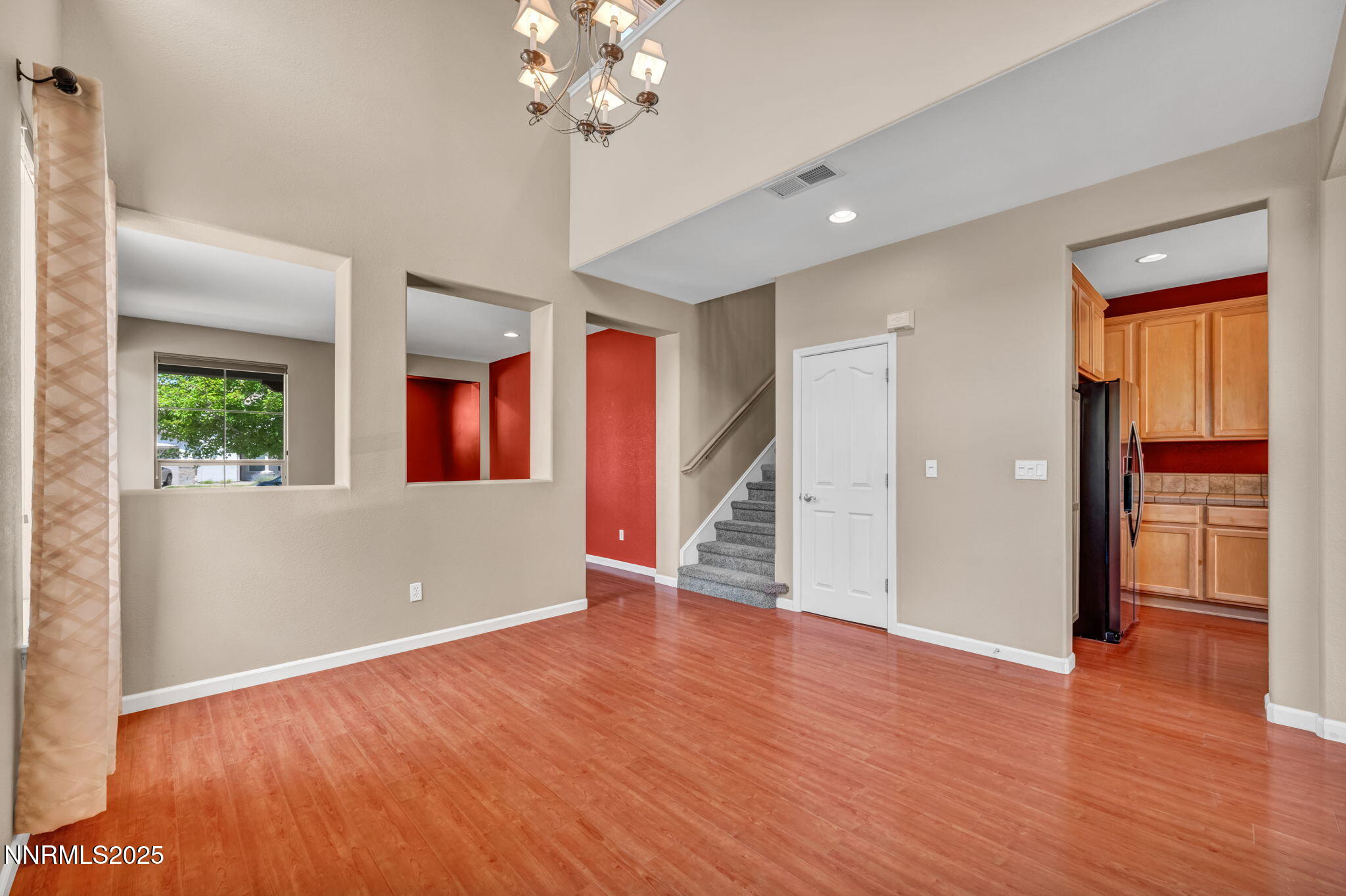 420 Miesque Court Reno, NV 89521 - Photo 9 of 43 a view of an empty room with window and wooden floor